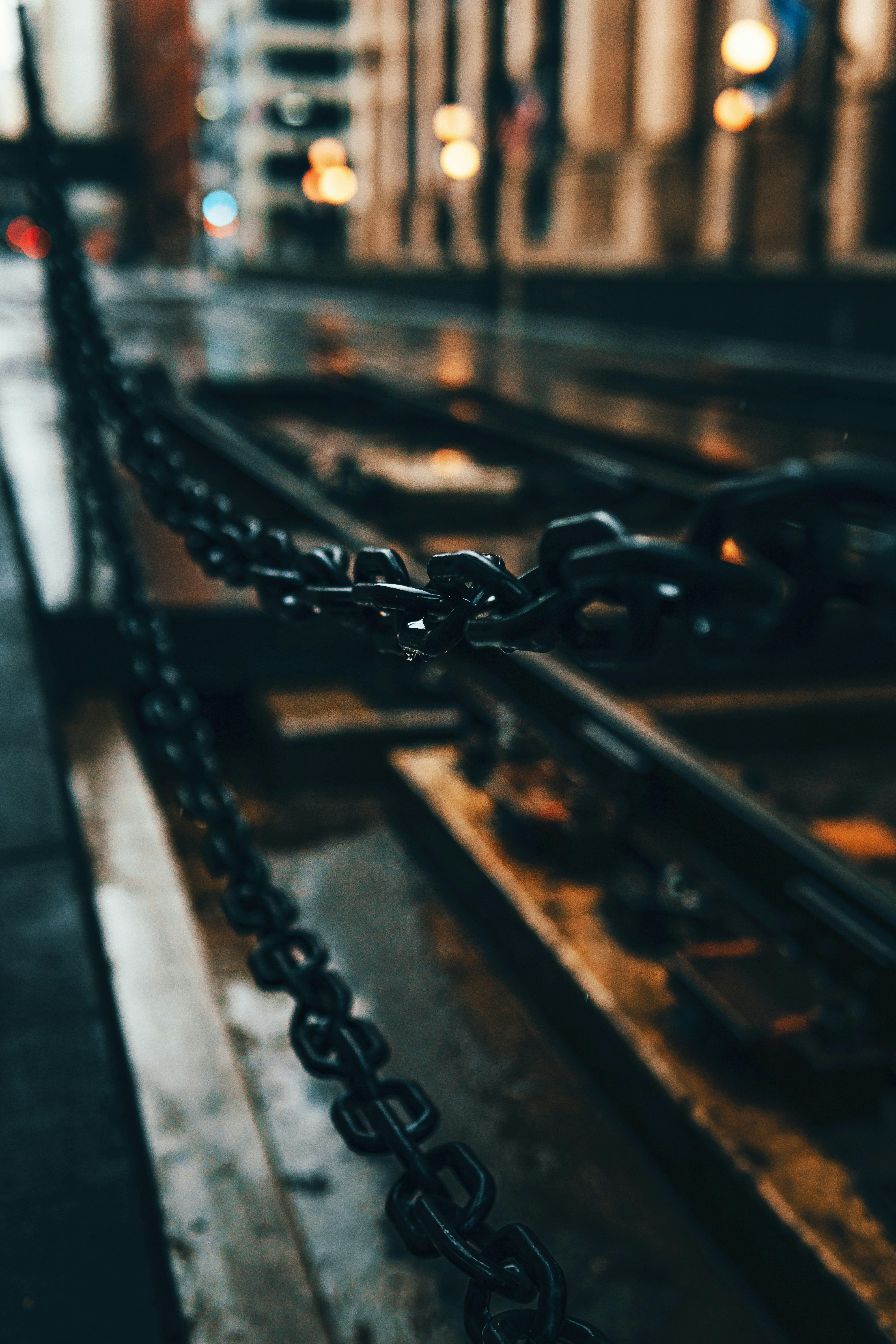 black metal chain on brown wooden plank